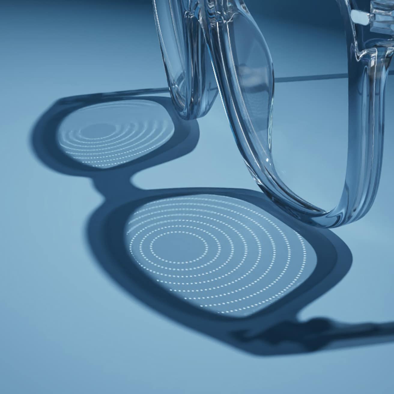 Essilor Stellest lenses resting on a blue surface